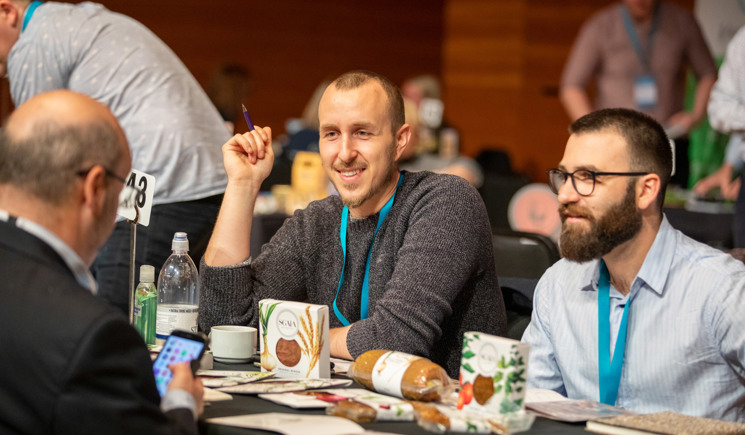 three men sitting at event table