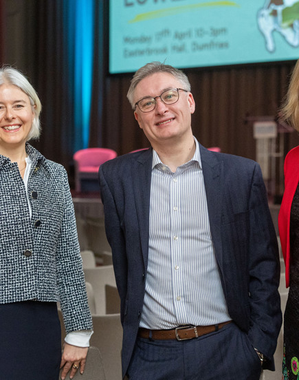 three people at conference smiling